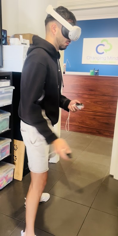 A young person using a virtual reality headset in the Changing Minds office